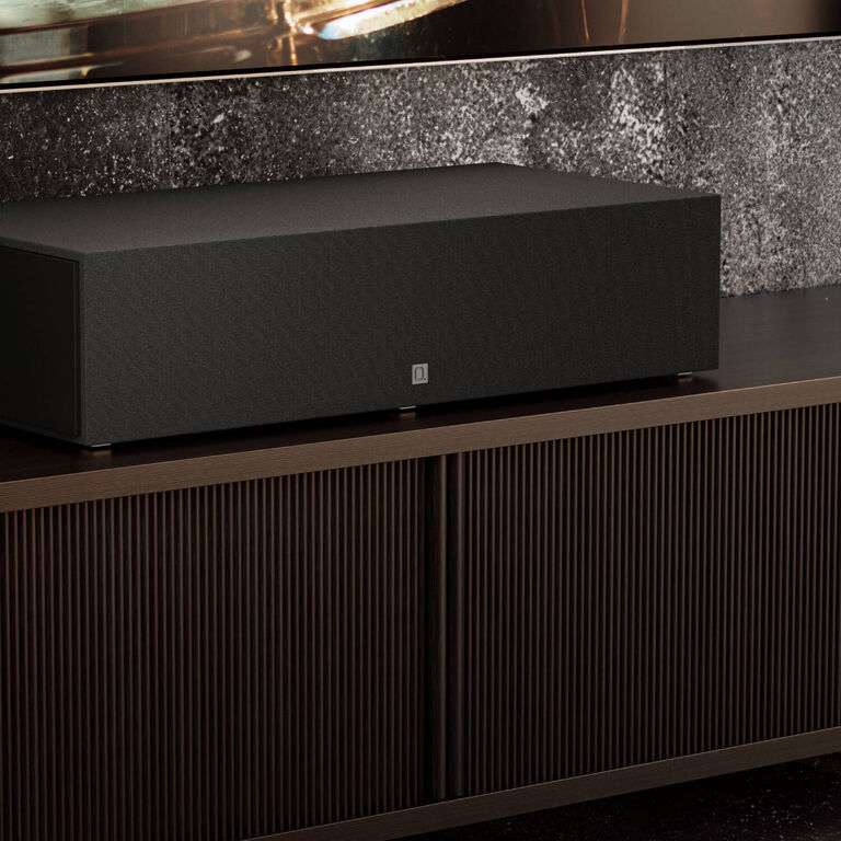 A center channel speaker sitting on a table.