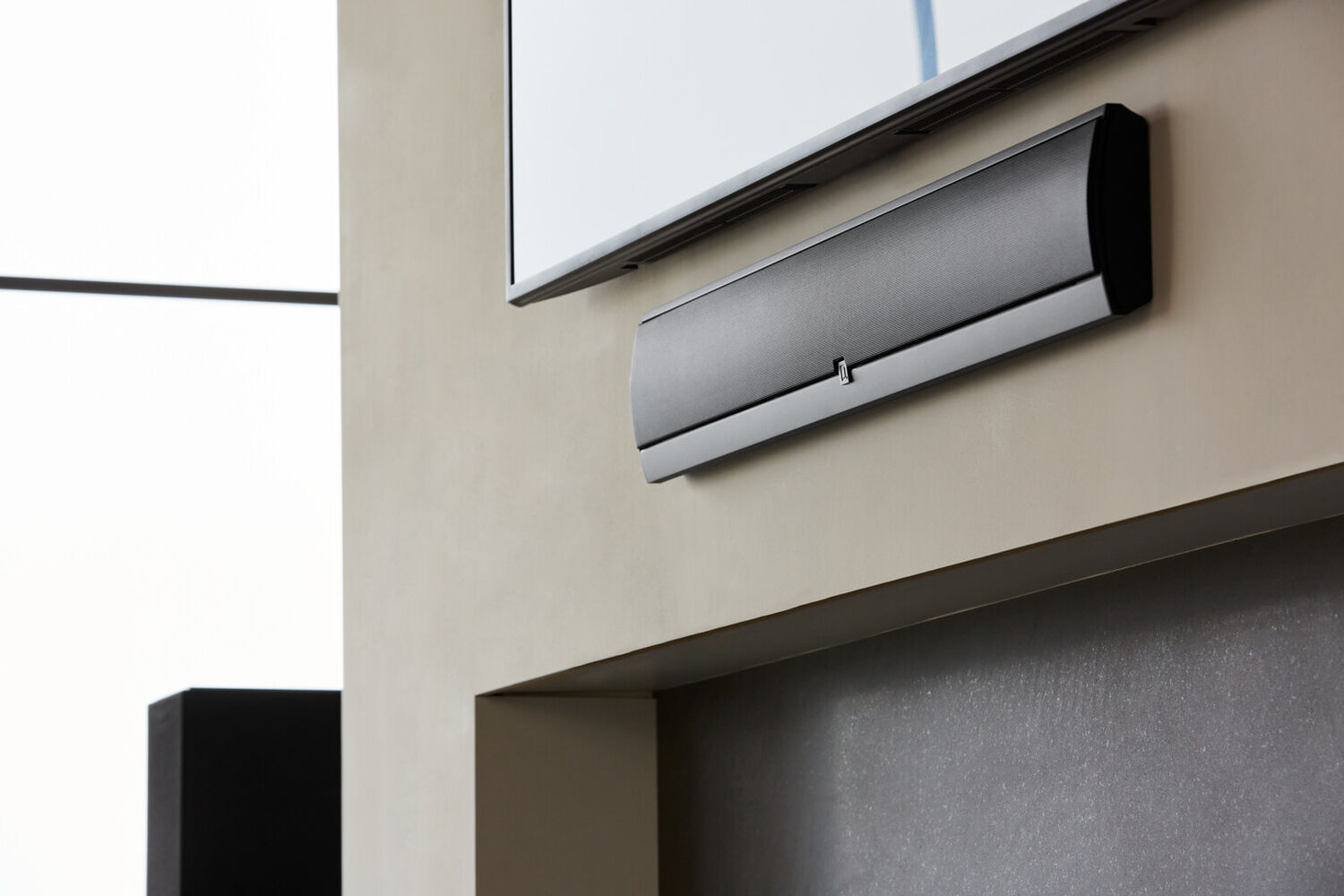 A speaker mounted to a wall