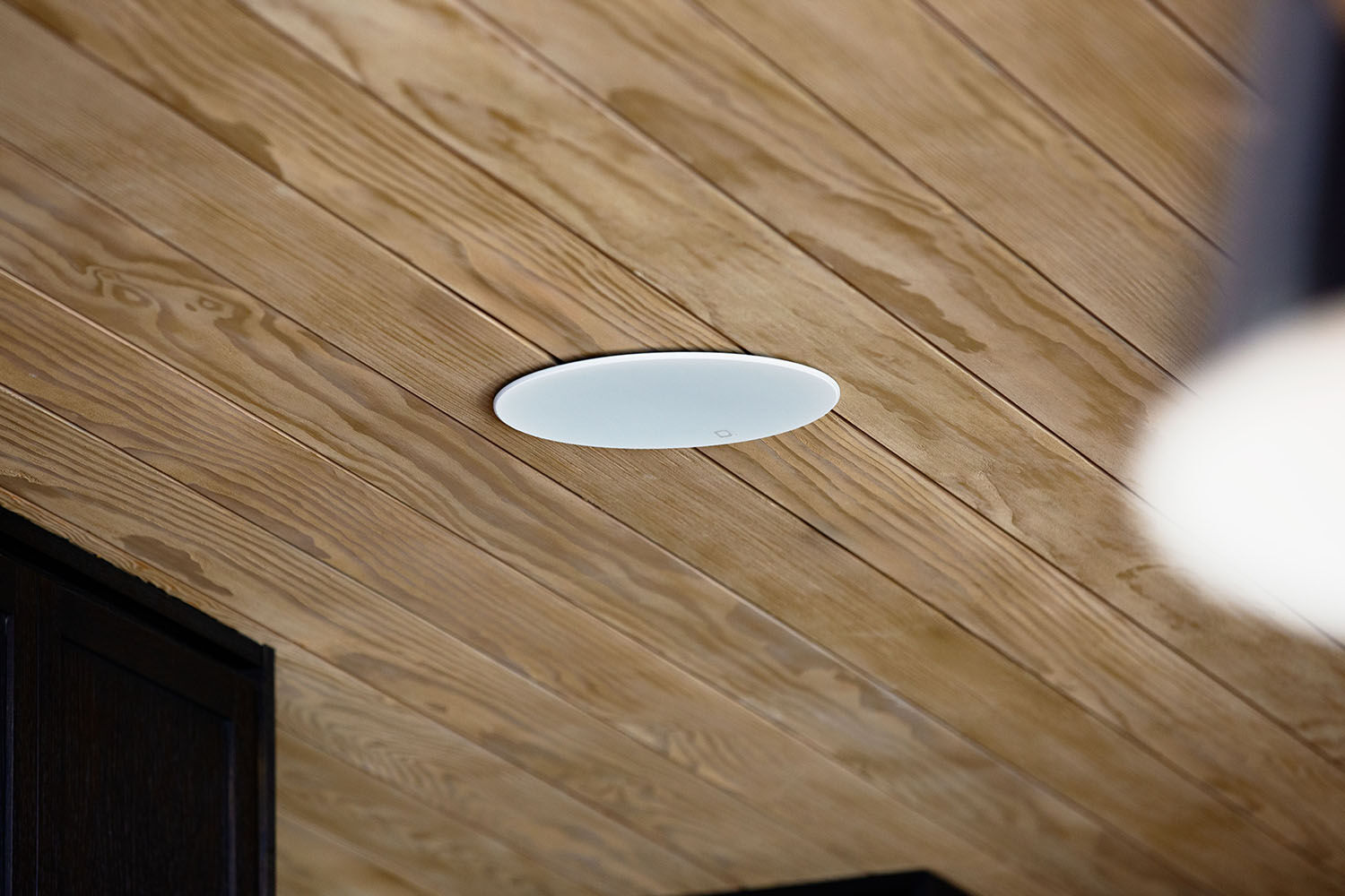 A speaker embedded in a ceiling