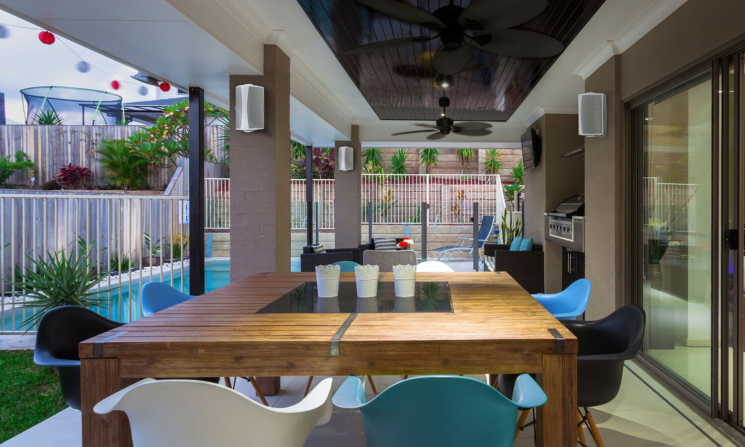 An outdoor patio with AW550 mounted on pillars