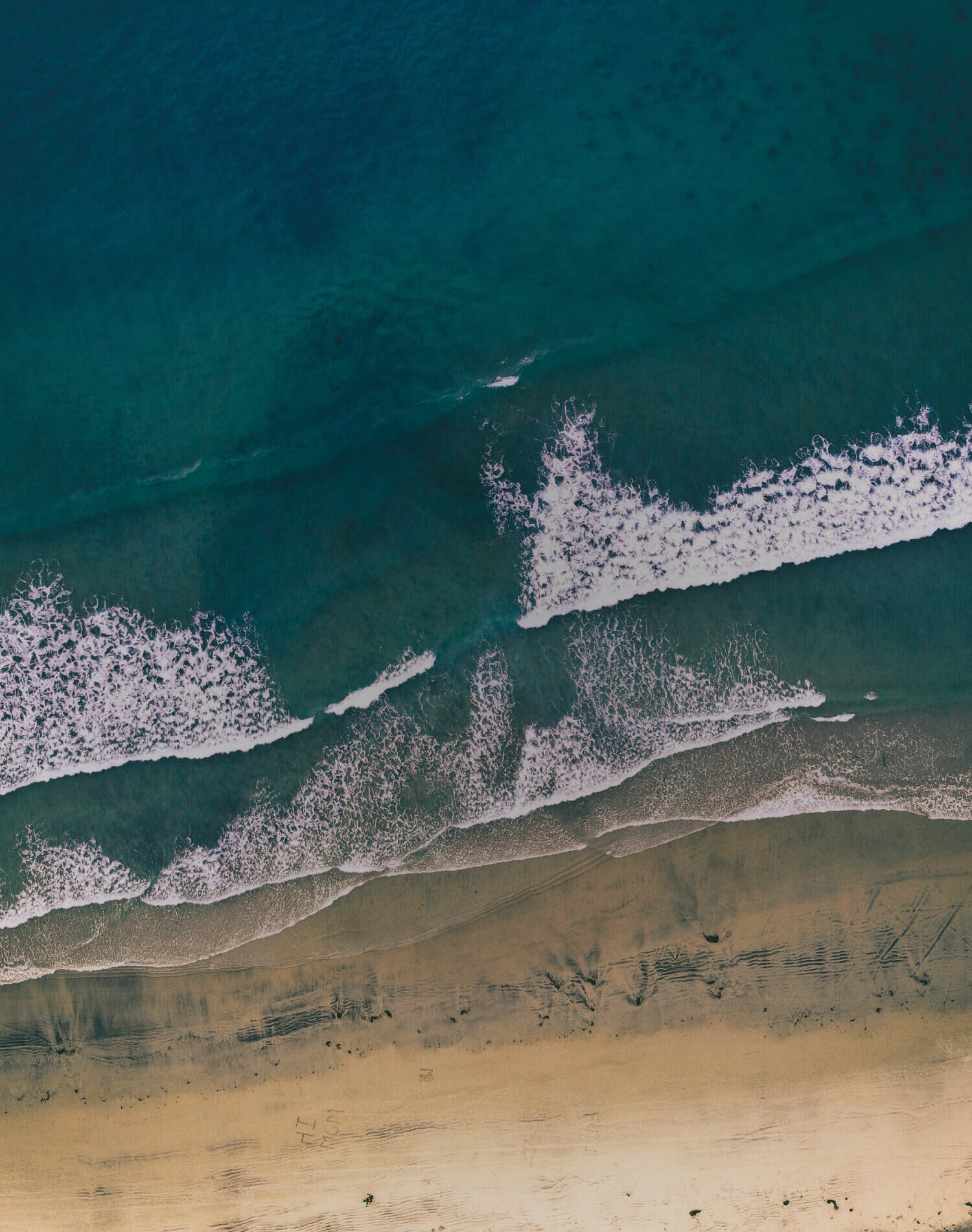 A top down view of beach waves.